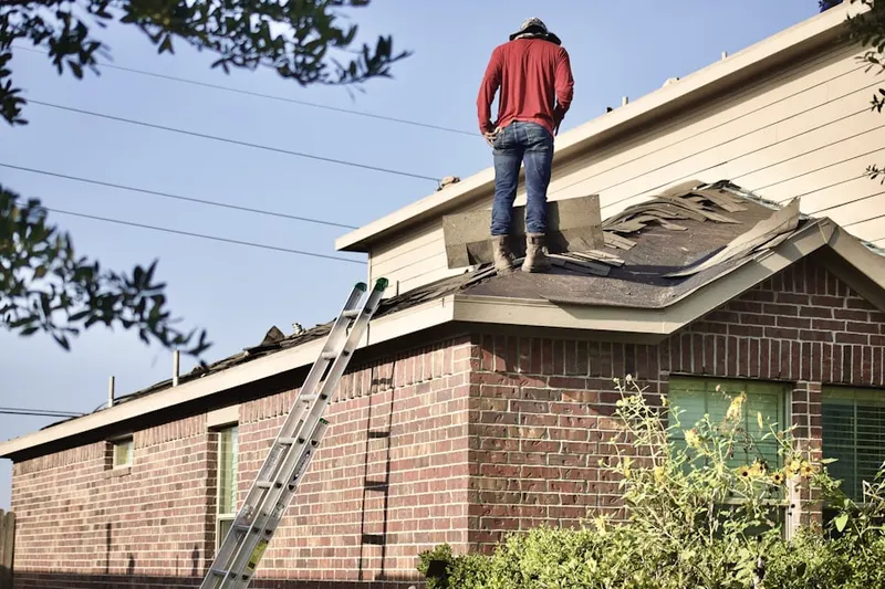 Professional roofer working on a residential roof in Cochran's Crossing